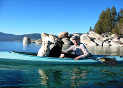 Owner and her 2 dogs in kayak on water